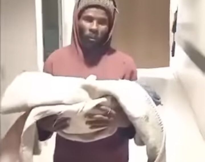 Video of a father holding a baby circulate on social media
